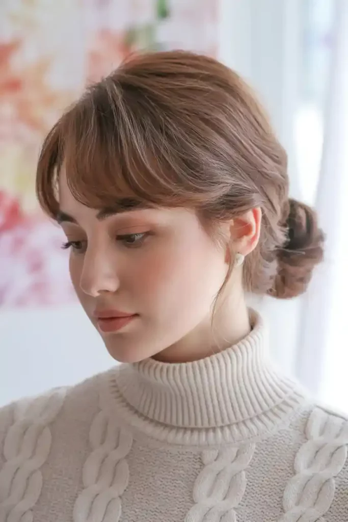 Low Bun with Side-Swept Bangs