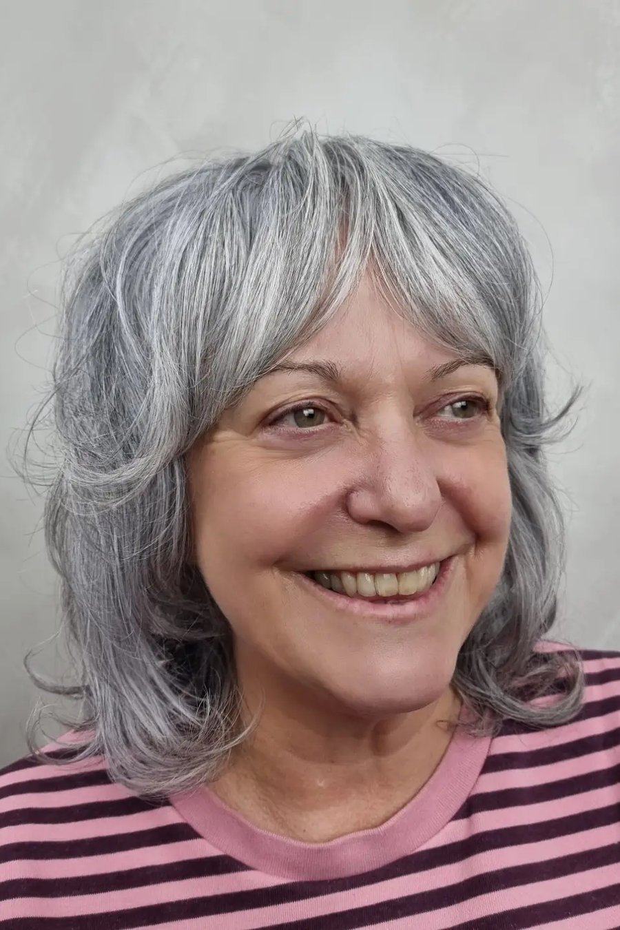 Face-Framing Layers with Wispy Bangs medium length hairstyle for women over 70