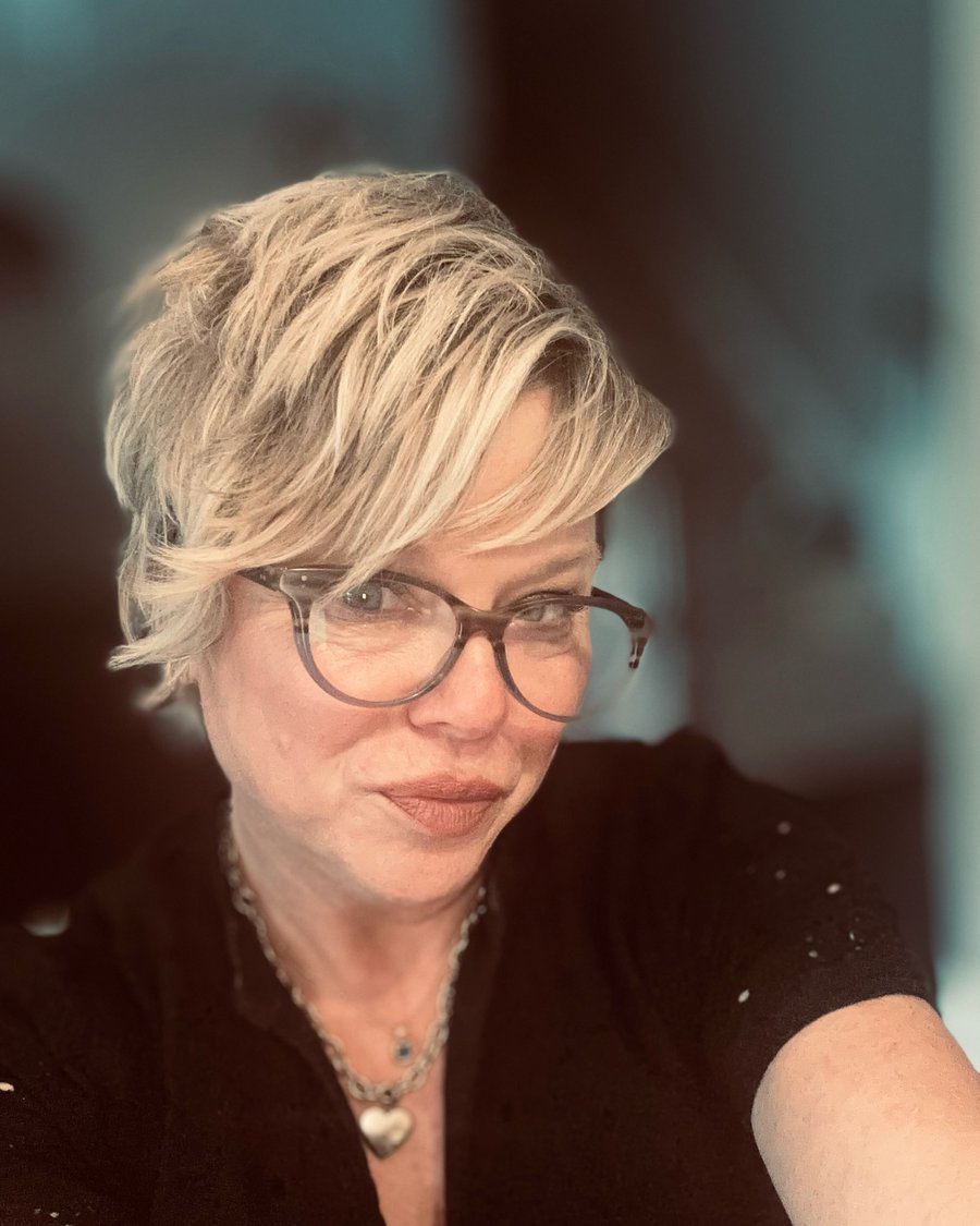 Long pixie cut with side-swept bangs and glasses