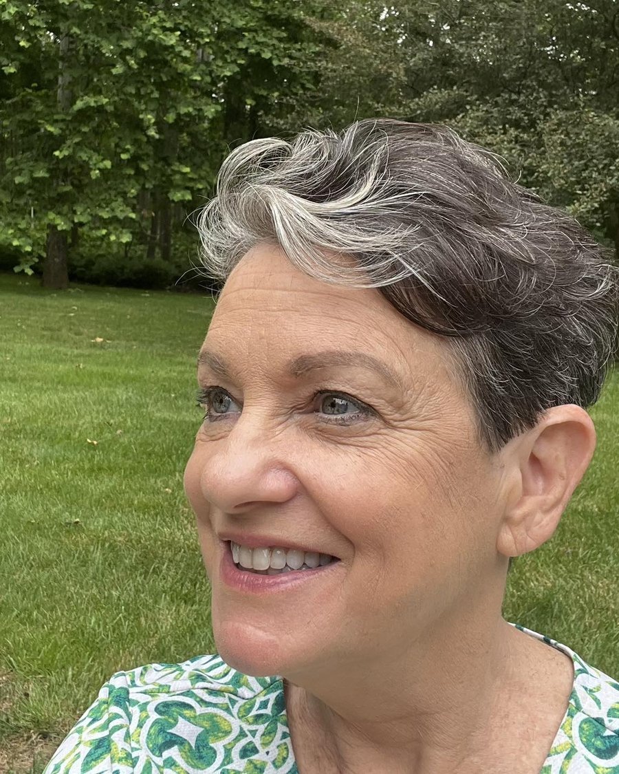 Feathered long pixie on mature woman outdoors