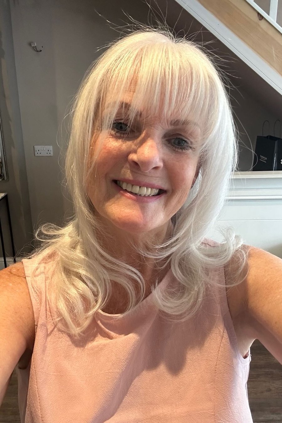 Long Bob with Wispy Bangs medium length hairstyle for women over 70