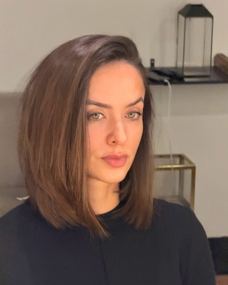 Woman with shoulder-length brown hair styled straight with internal layers