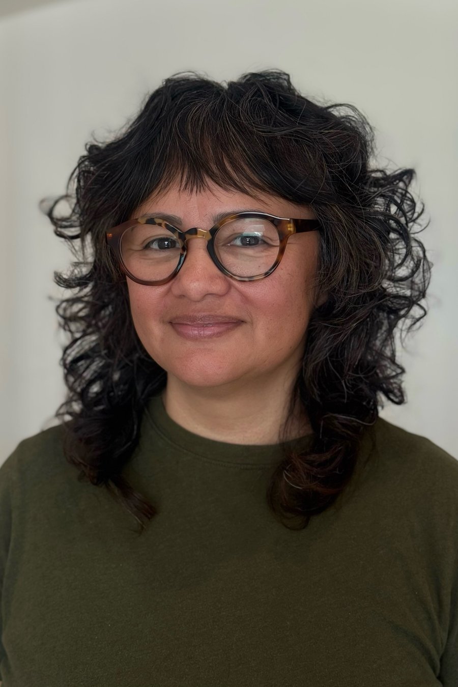 Layered Curls with Fringe medium length hairstyle for women over 70