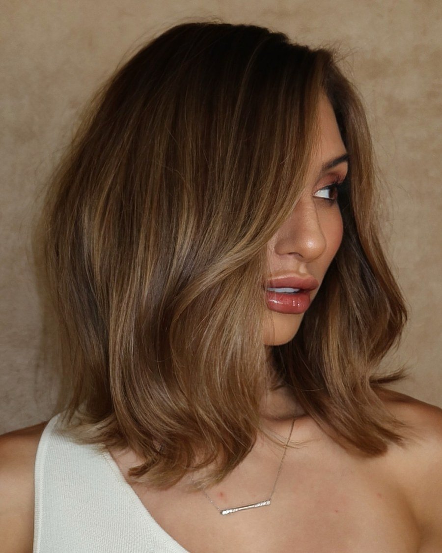 Close-up portrait of shoulder-length layered wavy bronde hair