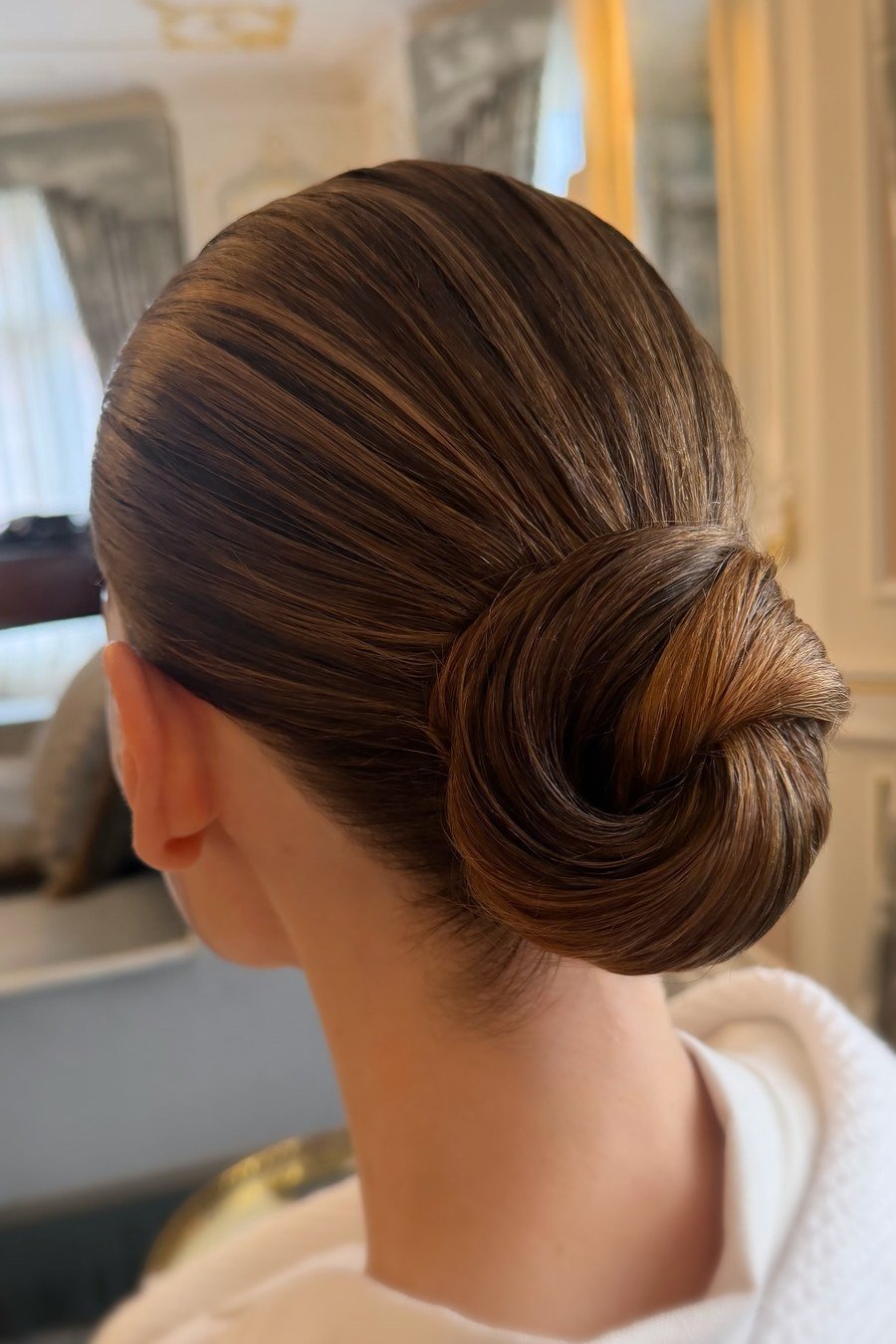 Sleek Low Bun with Middle Part bridesmaid hairstyle