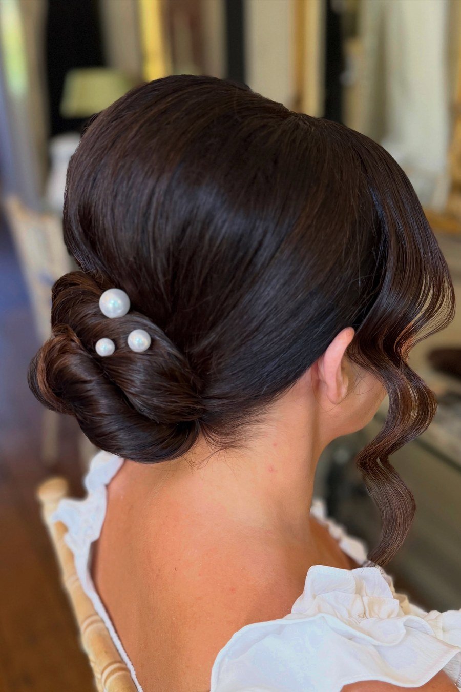 Pearl-Adorned Low Bun bridesmaid hairstyle