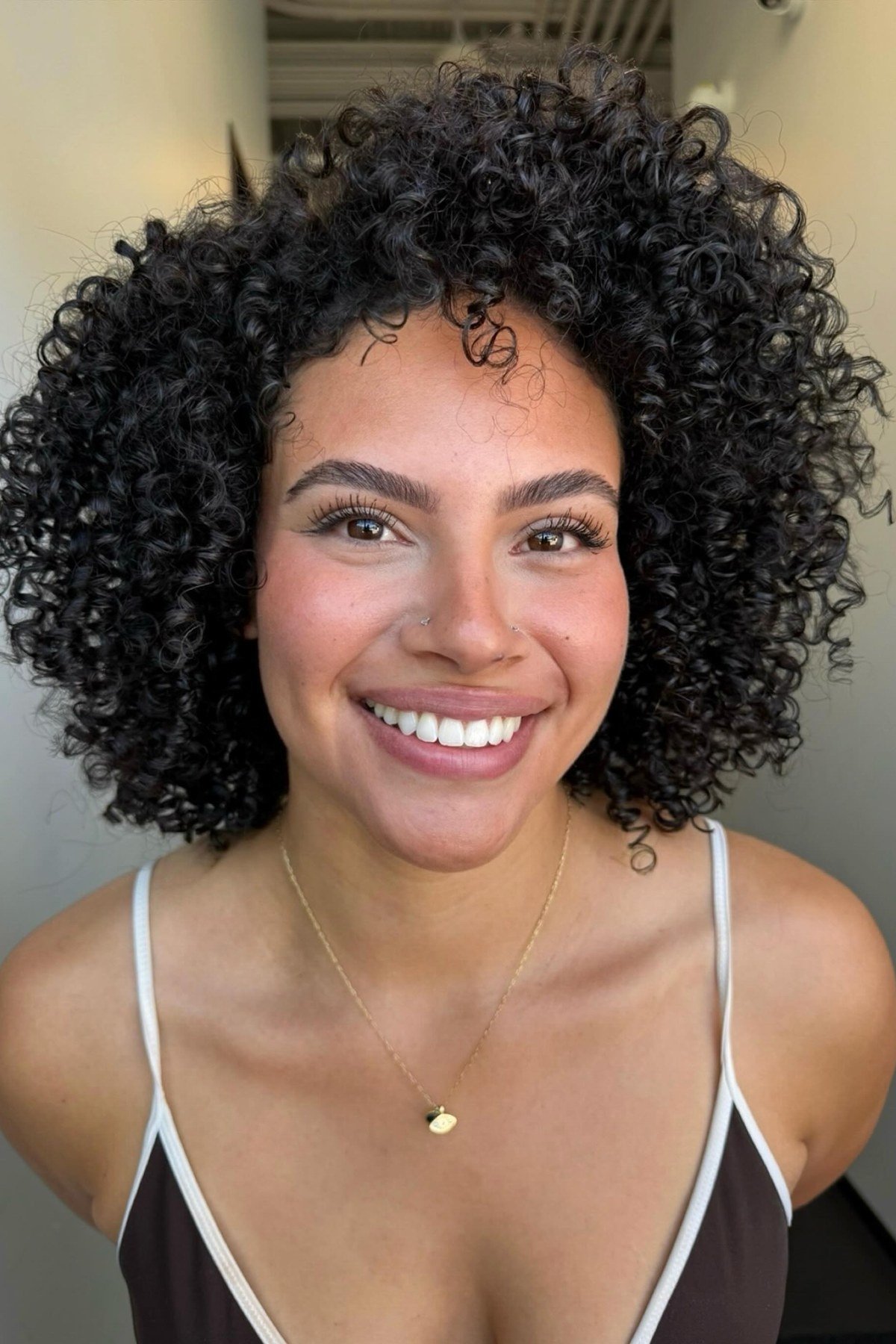 Woman with low maintenance thick hair short bob haircut smiling