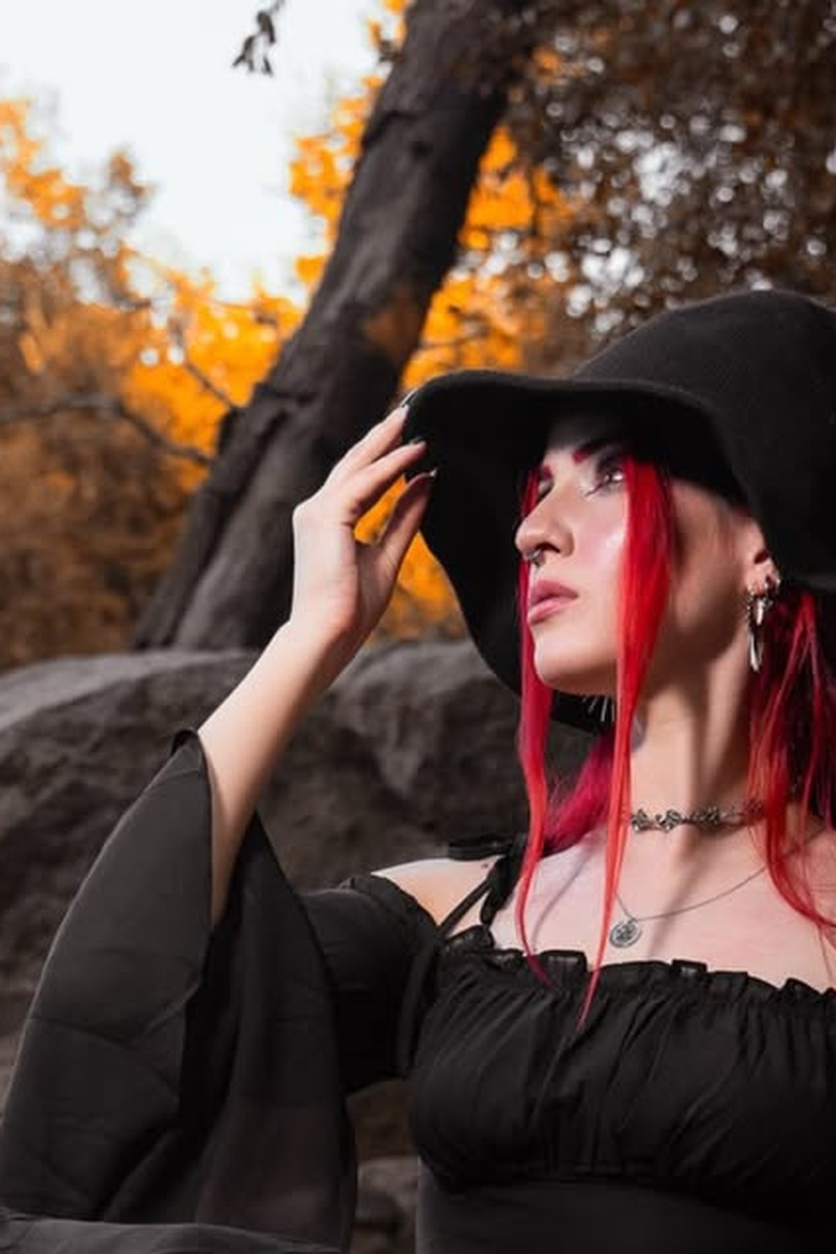 Enchanting witch hairstyle with dark waves and witch hat