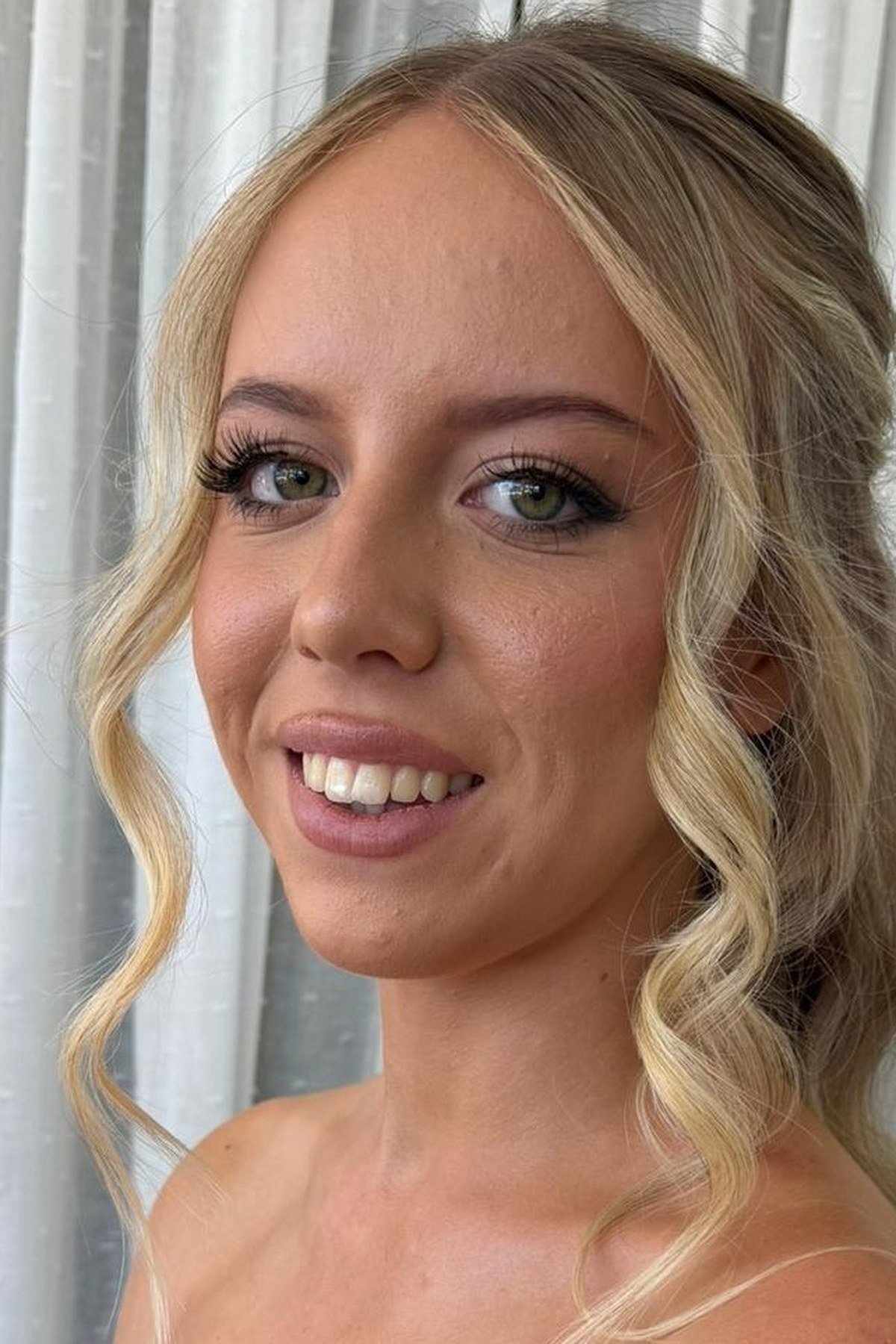 Beautiful half up half down hairstyles on a smiling woman — featured image