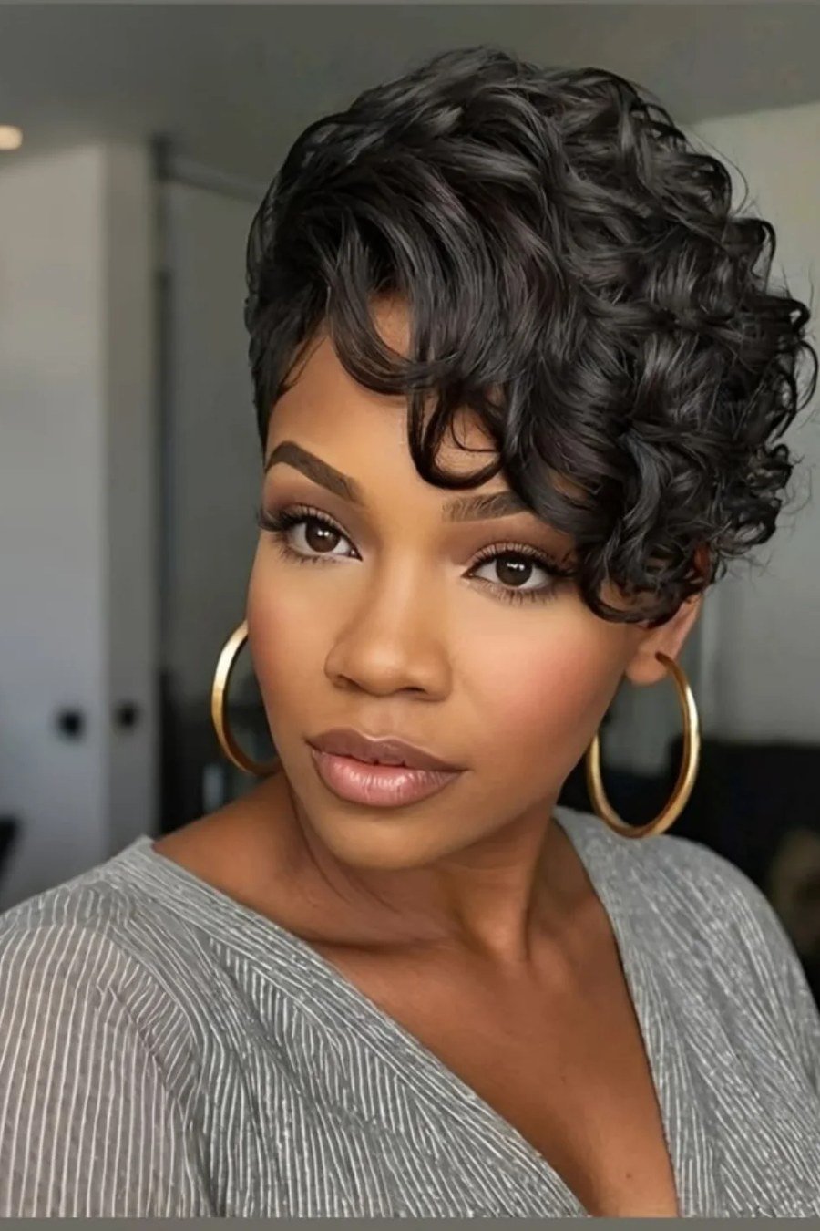 Voluminous Curly Pixie with Deep Side Part - layered short curly haircuts