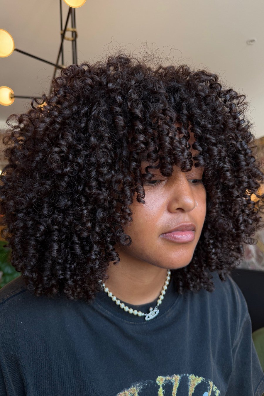 Layered Curly Bob with Wispy Bangs - layered short curly haircuts