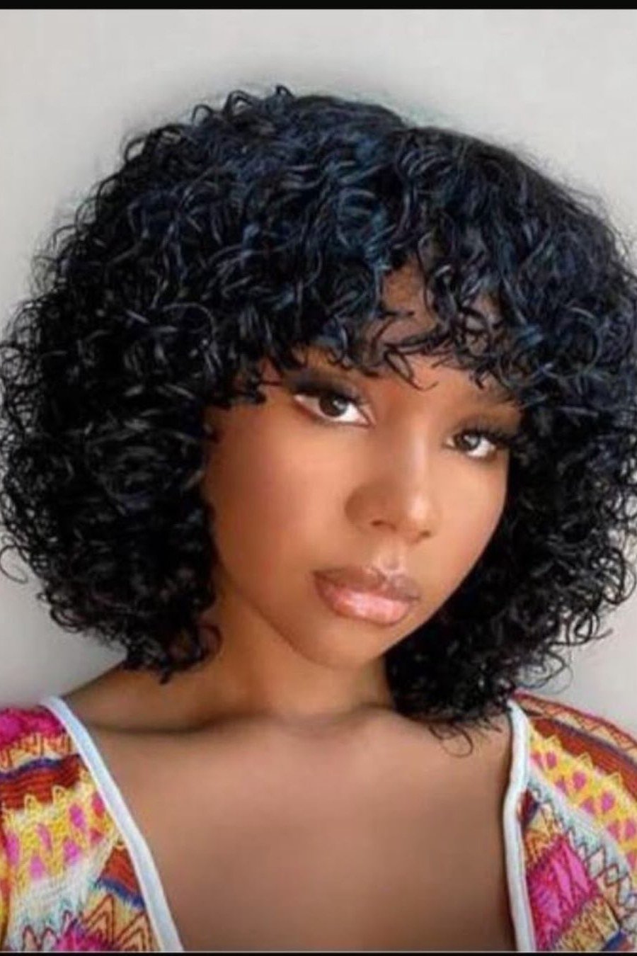 Curly Bob with Bangs — low maintenance black woman ear length short bob