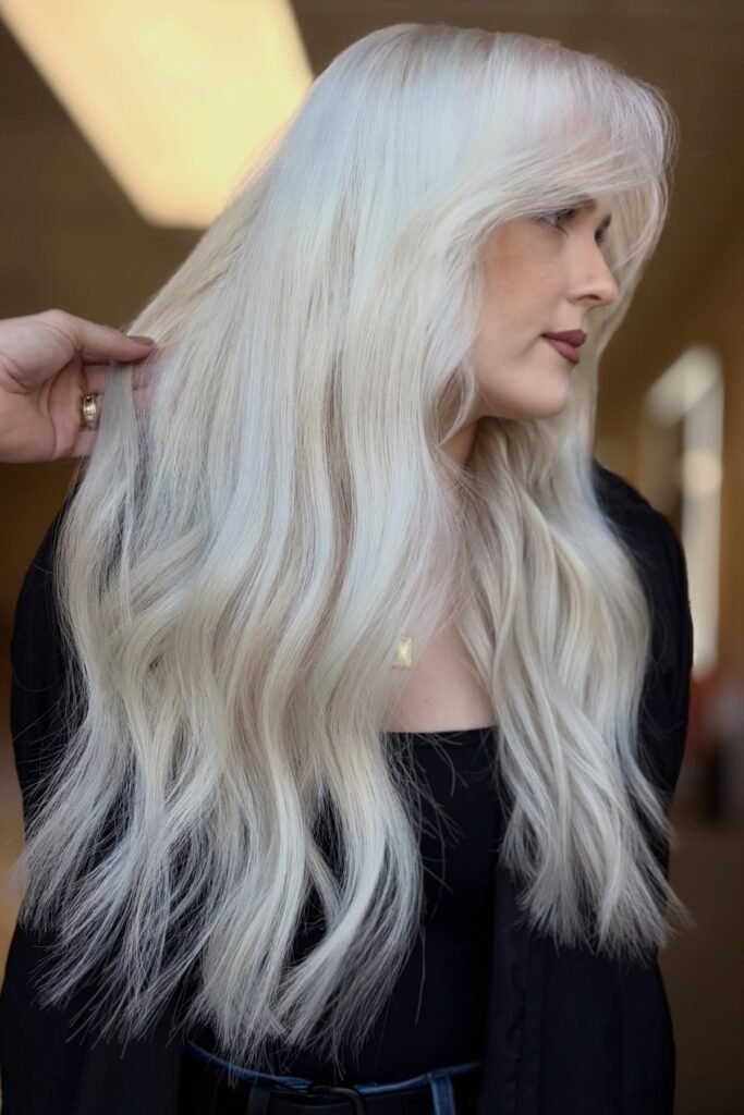 Dazzling platinum blonde highlights on long wavy hair - featured