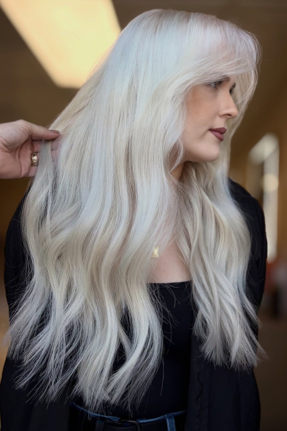 Dazzling platinum blonde highlights on long wavy hair - featured