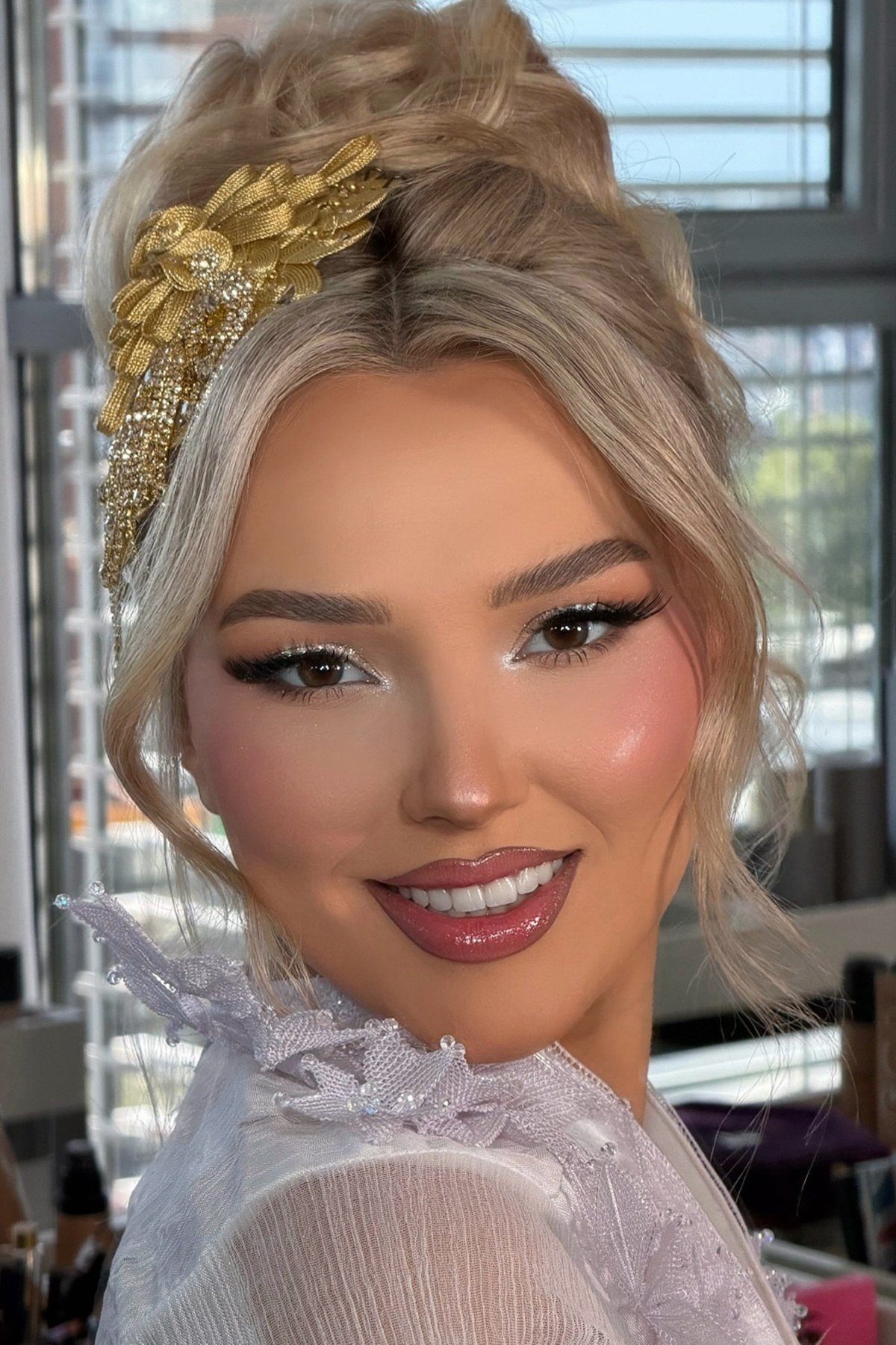 Elegant updo hairstyles on a smiling woman — featured image